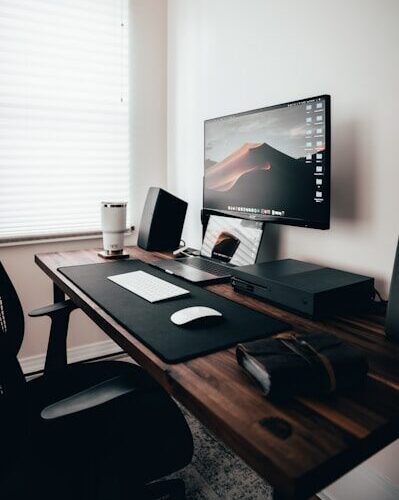 desktop turned on near window